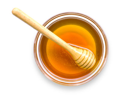 Image of honey with honey baller in glass dish