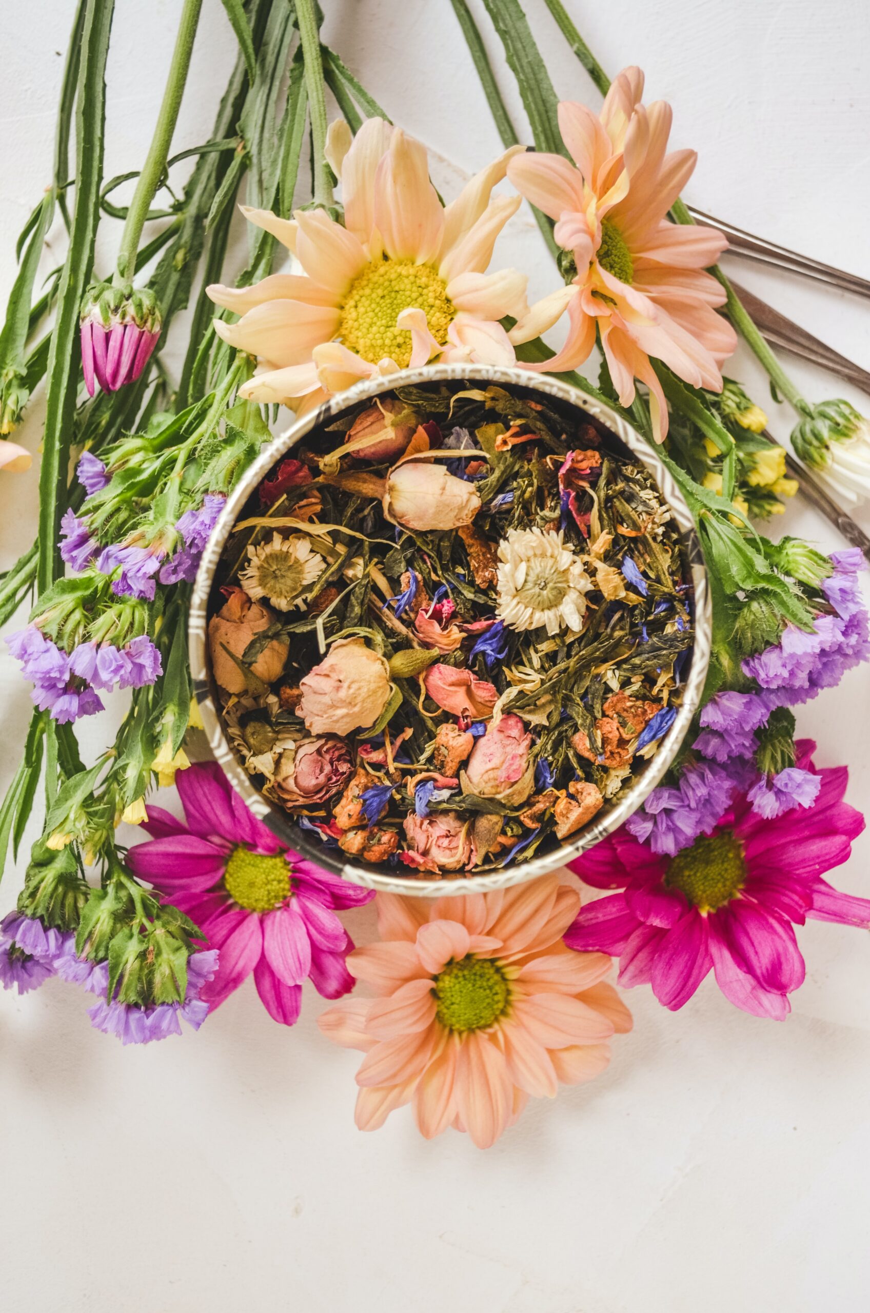 Image of dried flowers in bowl surrounded by cut flowers